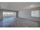 Bright living room featuring wood flooring, a large window with blinds, and neutral color palette at 100 Bluff View Dr # 514A, Belleair Bluffs, FL 33770