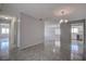 Bright open-concept living space with tile floors, neutral walls, and views into the kitchen and additional rooms at 100 Bluff View Dr # 514A, Belleair Bluffs, FL 33770