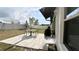 This home's backyard patio is ideal for enjoying outdoor living and is equipped with a grill and a table at 10854 Sage Canyon Dr, Riverview, FL 33578