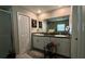 Bathroom featuring double sinks with granite countertops, and a large mirror, providing ample space at 10854 Sage Canyon Dr, Riverview, FL 33578