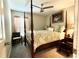 Traditional bedroom featuring a four-poster bed, ceiling fan, side table, and a comfortable seating area at 10854 Sage Canyon Dr, Riverview, FL 33578