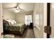 Bright bedroom featuring a ceiling fan, patterned bedding, curtains and chair at 10854 Sage Canyon Dr, Riverview, FL 33578