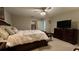 Serene bedroom with a ceiling fan, a walk-in closet, a dresser and tv set at 10854 Sage Canyon Dr, Riverview, FL 33578