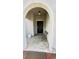 Inviting front porch with decorative tile, arched entryway, and a cozy seating area at 10854 Sage Canyon Dr, Riverview, FL 33578