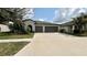 Charming single-story home with a well-manicured lawn and a two-car garage at 10854 Sage Canyon Dr, Riverview, FL 33578