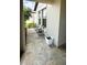 Tile front porch featuring seating area and view of the landscaped front yard at 10854 Sage Canyon Dr, Riverview, FL 33578