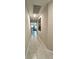 Clean hallway with modern tile flooring leads to kitchen and dining area at 10854 Sage Canyon Dr, Riverview, FL 33578