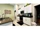Well-lit kitchen showcasing white cabinets, stainless steel appliances, and a granite countertop at 10854 Sage Canyon Dr, Riverview, FL 33578
