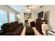 Comfortable living room with a sofa, ceiling fan, and natural light at 10854 Sage Canyon Dr, Riverview, FL 33578
