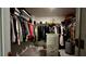 Spacious walk-in closet with extensive shelving, hanging rods and a dresser for optimal organization and storage at 10854 Sage Canyon Dr, Riverview, FL 33578
