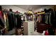 This walk-in closet offers organized storage with shelves and hanging rods for clothes and accessories at 10854 Sage Canyon Dr, Riverview, FL 33578