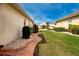 Manicured lawn and landscape with stone path in backyard at 1115 Signature Dr, Sun City Center, FL 33573