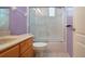 Bathroom with single vanity and shower with glass doors and natural light at 1115 Signature Dr, Sun City Center, FL 33573