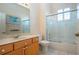 Bright bathroom featuring a tub and shower combo, vanity, and framed mirror at 1115 Signature Dr, Sun City Center, FL 33573