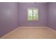 Bedroom features a window with bright natural light and neutral tile flooring at 1115 Signature Dr, Sun City Center, FL 33573