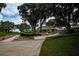 The community entrance is beautifully landscaped with mature trees and manicured gardens, creating a welcoming atmosphere at 1115 Signature Dr, Sun City Center, FL 33573