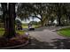 Golf carts are parked along a tree-lined path, highlighting the community's emphasis on leisure and recreation at 1115 Signature Dr, Sun City Center, FL 33573