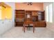 Dining room with built-in shelving, a table and chairs, and white tile flooring at 1115 Signature Dr, Sun City Center, FL 33573