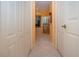 Hallway with tile floor leading to luxurious bathroom at 1115 Signature Dr, Sun City Center, FL 33573