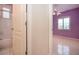 Hallway featuring a view of a bedroom with a window and ceiling fan at 1115 Signature Dr, Sun City Center, FL 33573
