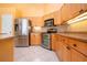 Updated kitchen with stainless steel appliances, custom cabinets, and granite countertops at 1115 Signature Dr, Sun City Center, FL 33573