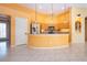 Kitchen island features counter seating, stainless appliances, and ample cabinet space at 1115 Signature Dr, Sun City Center, FL 33573
