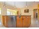 Kitchen island featuring a stainless steel dishwasher, granite countertop, and a sink at 1115 Signature Dr, Sun City Center, FL 33573