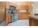 Kitchen features stainless steel appliances, custom cabinets, and granite countertops at 1115 Signature Dr, Sun City Center, FL 33573