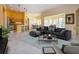 Stylish living room featuring a comfortable sofa, kitchen, and open-concept layout perfect for entertaining at 1115 Signature Dr, Sun City Center, FL 33573
