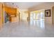 Open living space with tile floors, a kitchen island, and sliding doors to an outdoor patio at 1115 Signature Dr, Sun City Center, FL 33573