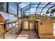 Well-equipped outdoor kitchen with stainless steel appliances integrated into a stone-clad bar area at 1115 Signature Dr, Sun City Center, FL 33573