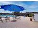 An outdoor pool area with tables, chairs, umbrellas, and lounge chairs, perfect for relaxing on a sunny day at 1115 Signature Dr, Sun City Center, FL 33573