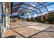 A spacious covered patio with an outdoor kitchen and a view of the backyard at 1115 Signature Dr, Sun City Center, FL 33573