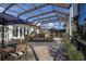 Inviting screened pool patio with dining and lounging area, perfect for relaxation and entertaining at 1115 Signature Dr, Sun City Center, FL 33573