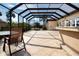 Open tiled pool patio with outdoor kitchen, dining table and seating, perfect for outdoor living at 1115 Signature Dr, Sun City Center, FL 33573