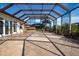 Expansive screened-in pool patio featuring tiled flooring, an outdoor kitchen and a dining area at 1115 Signature Dr, Sun City Center, FL 33573
