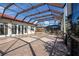 Spacious screened pool patio with tile flooring and complete outdoor kitchen, ideal for entertaining guests at 1115 Signature Dr, Sun City Center, FL 33573