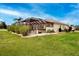 A spacious screened-in patio offers serene outdoor living with lush landscaping and access to the home's interior at 1115 Signature Dr, Sun City Center, FL 33573