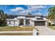 Charming single-story home with well-maintained lawn, solar panels and mature trees at 1123 Hounds Run, Safety Harbor, FL 34695