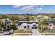 Beautiful single-story home with solar panels, a well-manicured lawn, and a serene pond view at 1123 Hounds Run, Safety Harbor, FL 34695