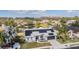 Pictureque white home with solar panels overlooks a lush landscape and tranquil pond at 1123 Hounds Run, Safety Harbor, FL 34695