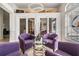 Bright foyer with wine storage, high ceilings, tile floors and four comfortable chairs at 1123 Hounds Run, Safety Harbor, FL 34695