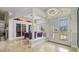 Bright foyer with high ceilings, decorative columns, tile floors and wine storage at 1123 Hounds Run, Safety Harbor, FL 34695
