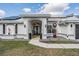 Inviting front entrance with double doors, arched entryway, and manicured landscaping at 1123 Hounds Run, Safety Harbor, FL 34695