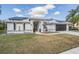 Attractive home with solar panels, arched entryway, and well-maintained lawn at 1123 Hounds Run, Safety Harbor, FL 34695