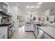 Modern kitchen with stainless steel appliances, sleek countertops, and a view of the pool area at 1123 Hounds Run, Safety Harbor, FL 34695