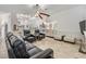 Spacious living room featuring tile floors, modern ceiling fan and bar area; perfect for entertaining guests at 1123 Hounds Run, Safety Harbor, FL 34695