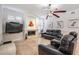 Stylish living room with fireplace, travertine flooring, and comfortable leather seating at 1123 Hounds Run, Safety Harbor, FL 34695