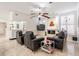 Living room boasts travertine flooring, fireplace, bar, with comfortable leather seating and modern decor at 1123 Hounds Run, Safety Harbor, FL 34695