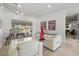 Elegant living room with tile floors, white recliner seating and backyard views at 1123 Hounds Run, Safety Harbor, FL 34695
